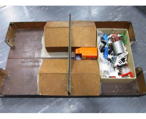 A MODEL FARMYARD of wood and hardboard home construction; together with a quantity of plastic farm animals and accessories by
