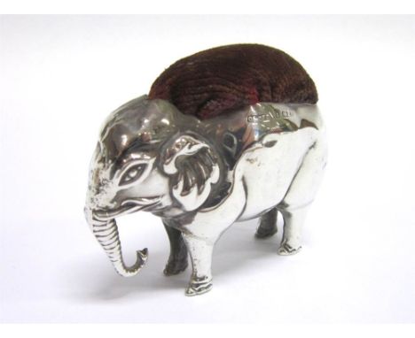 A LARGE SILVER ELEPHANT PIN CUSHION  by Saunders & Shepherd, Birmingham 1905, the standing animal with trunk down, 6.7cm long