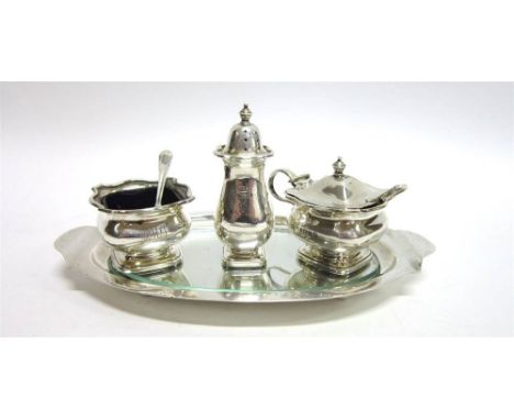 A SILVER THREE PIECE CRUET SET with stand, maker W.H.M. Birmingham 1935, with Jubilee mark, the spoons by Adie Brothers, Birm