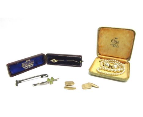 A DIAMOND AND MOTHER OF PEARL STICKPIN cased; with a Connemara marble clover leaf brooch; a riding crop brooch; a pair of gil