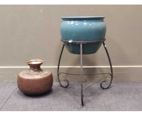 A blue ceramic jardinere on wrought iron stand 60cm high including stand, together with a embossed copper vase 26cm high (2)T