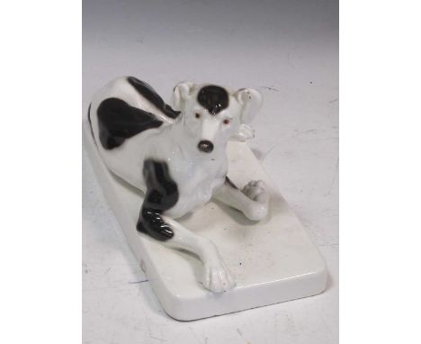 A Goldscheider figure of a reclining dog, 14.5 x 12 x 25.5cm