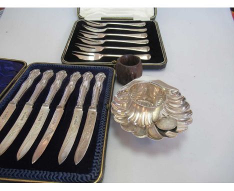 A collection of silverware including a shell dish, napkin ring, cased manicure set, cased set of dessert knives with sliver b