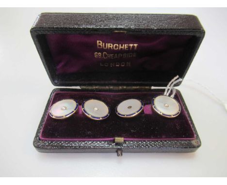 A pair of enamel and mother of pearl cufflinks (one split pearl lacking), stamped '18CT', gross weight 7.3g