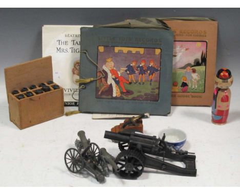 A lead grey painted model Howitzer, unmarked but probably by Britains, with tractor wheels, other artillery toy models, a sol
