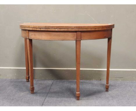 An early 19th century walnut card table on square tapering legs with green felt inset, 73 x 106 x 48cm (closed), 70 x 106 x 9