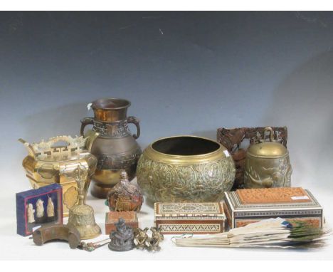 An Eastern carved wood and mother of pearl box together with two other boxes, a peacock feather fan, embossed bell, flask and