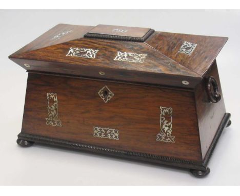 A Regency rosewood and mother of pearl tea caddy, of sarcophagus shape, 34cm wide