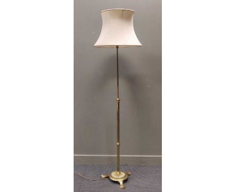A brass adjustable standard lamp on tripod base, 116cm