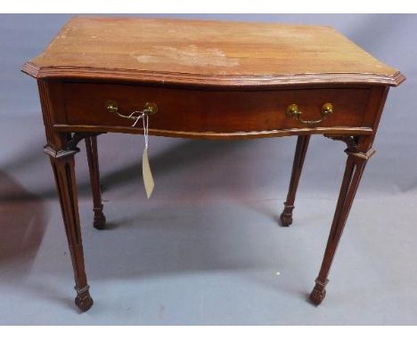 An early 20th century mahogany serpentine fronted side table, with single drawer, raised on carved tapered legs, in the Chipp