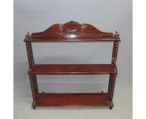 An early 20th century mahogany wall hanging waterfall bookcase, with bobbin supports, H.80 W.75 D.18cm 