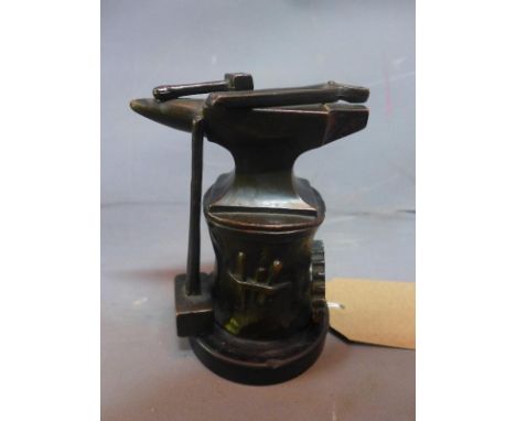 A cast bronze study of an anvil and blacksmith's tools, on a circular marble base, H.14cm (a/f) 