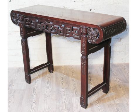 A Chinese altar table, late 19th century, carved frieze with scroll ends and carved square legs, length 120cm, depth 29cm &am