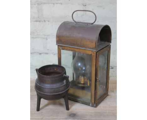 A brass lantern and a cast iron cauldron.  