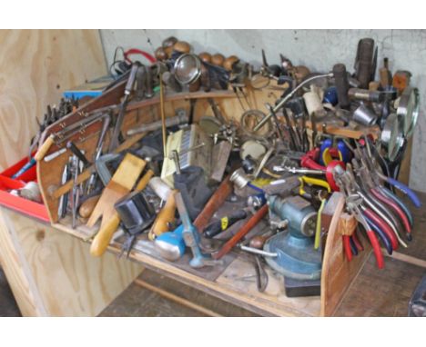 A jeweller's or watch makers work station with various tools including hammers, pliers, specialist tools, vices etc. 