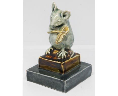 A rare Doulton Lambeth figure attributed to George Tinworth circa 1885, formed as a mouse playing the violin on square two st