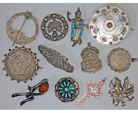A mixed lot of mainly silver brooches comprising a hallmarked silver Celtic style plaid pin, a hallmarked silver thistle broo