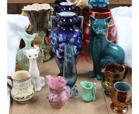 A Poole pottery cat together with a copper lustre jug, a purple lustre hunting jug, Withernsea pottery vase, a pair of potter