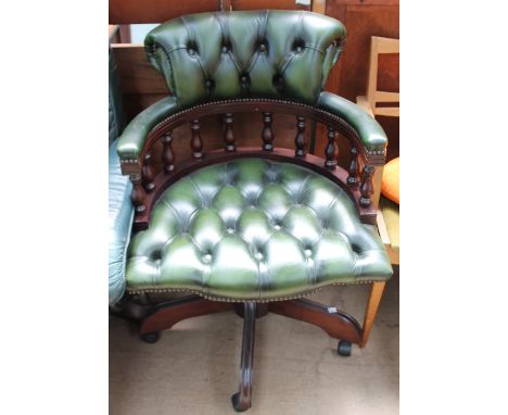 A green leather button upholstered office chair