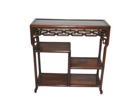 A Chinese hardwood rectangular open display stand with pierced scroll frieze above three shelves on slender legs, 65cm wide x
