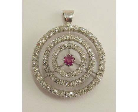 A ruby and diamond pendant the central round cut claw set ruby is surrounded with three circlets of old brilliant cut diamond