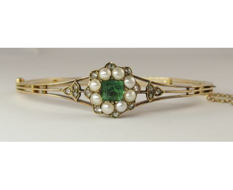 An emerald, diamond and pearl vintage bangle set with rose cut diamonds and a cushion cut emerald and split pearls to the thr