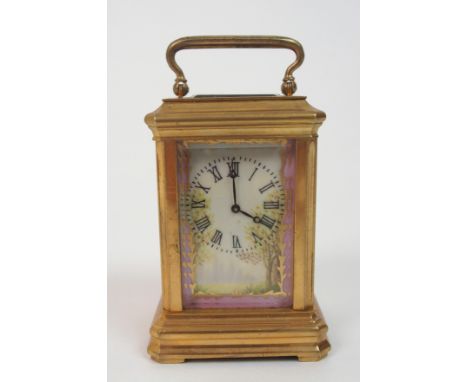 A Miniature French carriage clock the brass frame with painted porcelain panels depicting girls and landscapes, the dial with