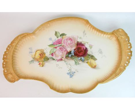 A large Doulton Burslem platter painted by Louis Bilton decorated with large roses and harebells on a cream ground with gilde