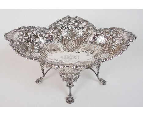 An Edwardian silver basket by R & W Sorley, Glasgow 1900, of scalloped boat shape with pierced decoration, the edge with scro