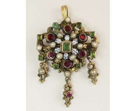 An Austro-Hungarian pendant brooch of gilded white metal set with garnets, emeralds and pearls with further blue and white en