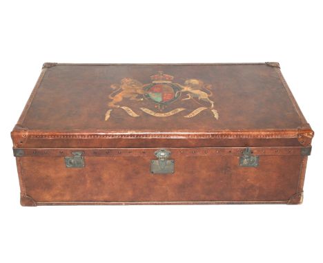 A 20th Century leather decorative trunk with painted coat of arms, hinged and nailed with carrying handles, 127cm wide x 78cm