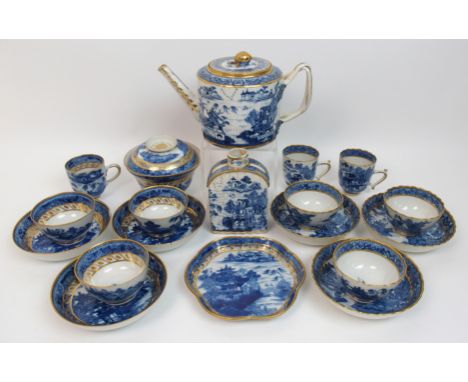 An early 19th Century English Willow pattern tea set comprising; a teapot with entwined handles with leaf and berry terminals