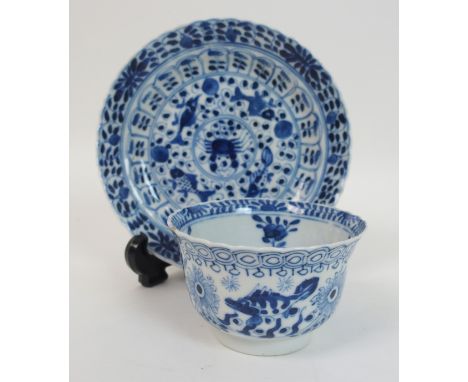 A Chinese blue and white tea bowl and saucer painted with fish surrounding a crab amongst foliage, bears Kangxi marks (2)