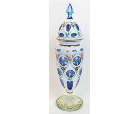 A 19th Century Bohemian overlaid glass vase and cover overlaid white over blue, cut with circular windows and decorated with 