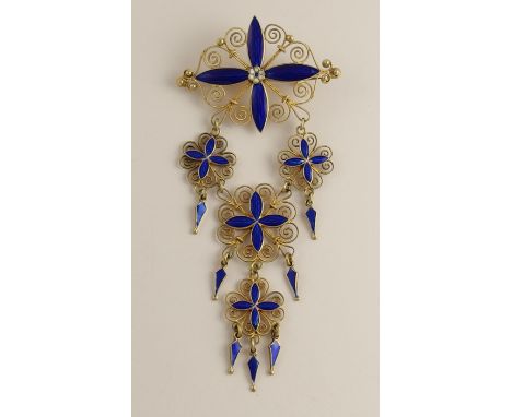 A traditional Norwegian solje enamel brooch made by Marius Hammer in silver gilt filigree with blue and white enamelled penda