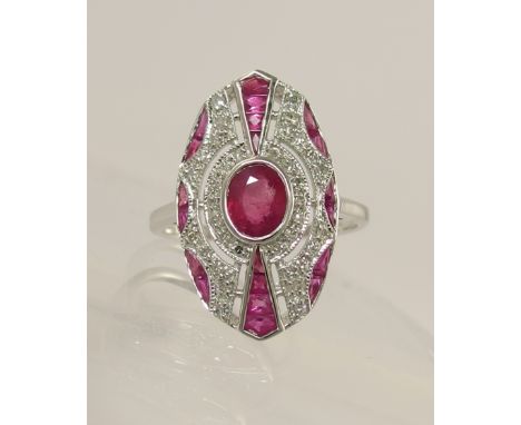 A 14ct ruby and diamond Art Deco style ring of pierced design set with a central ruby of approx measurements 6mm x 4mm, with 