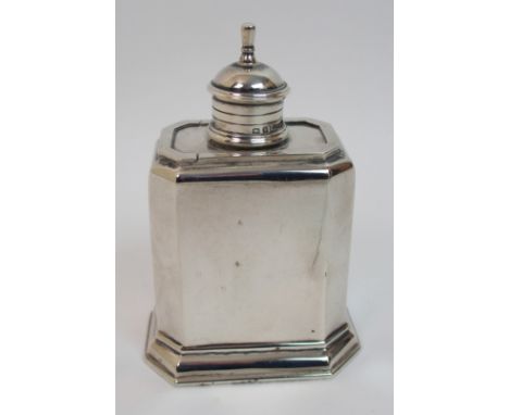 A silver tea caddy by George Unite & Sons, Birmingham 1926, of rectangular form with canted corners on stepped base, the slid