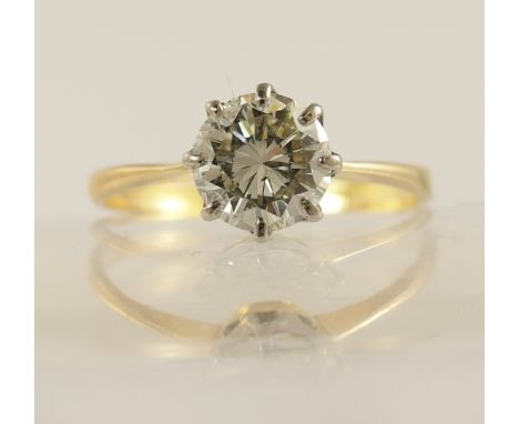 A 1.12ct diamond solitaire ring with classic crown mount in white metal with a tapered yellow metal shank, finger size R