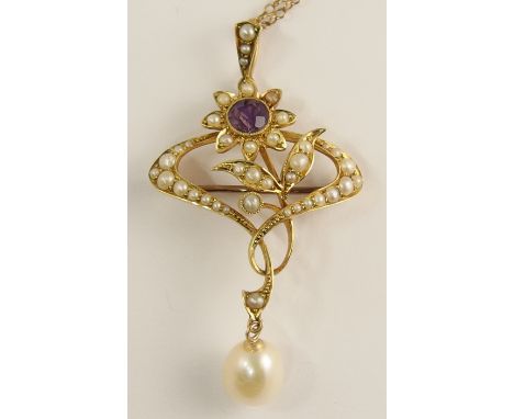An Art Nouveau flower pendant brooch of classic whip lash design set with an amethyst and split pearls, with a large baroque 