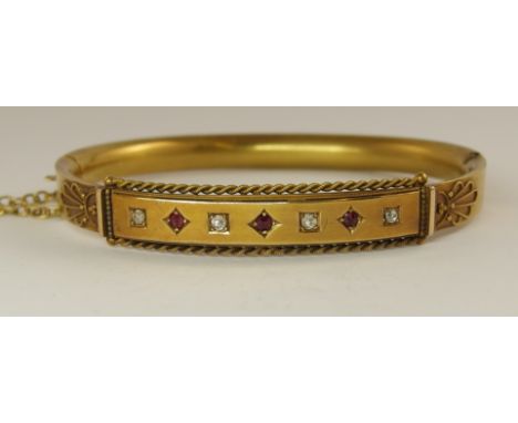 A 15ct gold Victorian ruby and diamond bangle with wire and bead work decoration, diameter 60mm x 50mm