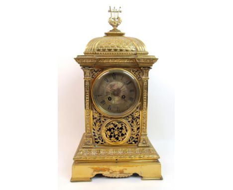 A 19th Century pierced brass mantle clock of rectangular base, the decoration of pierced foliate form, the side panels decora