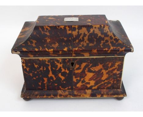 A Georgian tortoiseshell double tea caddy of sarcophagus form the lid with inlaid rectangular white metal lozenge, the interi