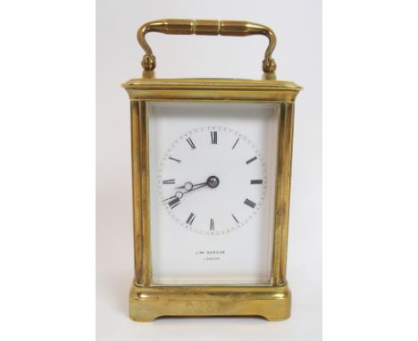 A French brass carriage clock plain white enamel dial with Roman numerals, signed J W Benson, London, 12cm high
