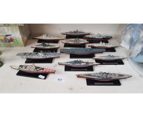 12 model warships on plinths, largest 22cm long - including HMS Ark Royal, HMS Vanguard, Tirpitz, Admiral Graf Spee etc.
