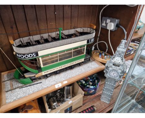 A model tram, a Meccano model Big Ben and a Jaques London solitaire game.