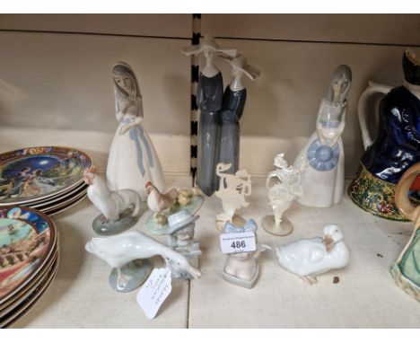 A collection of 11 figurines including 1 Lladro goose, some Nao, along with similar style figures