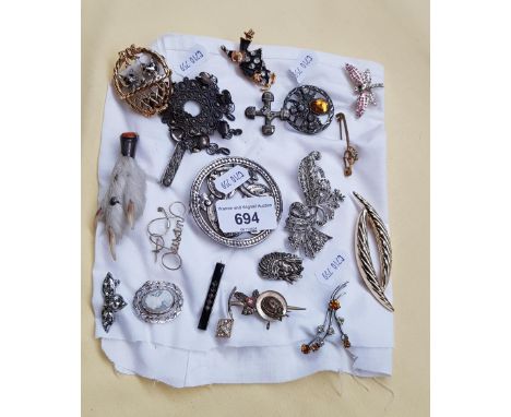 A collection of vintage brooches including silver. 