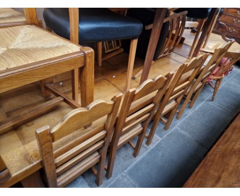 A modern light oak farm house table and six chairs. 