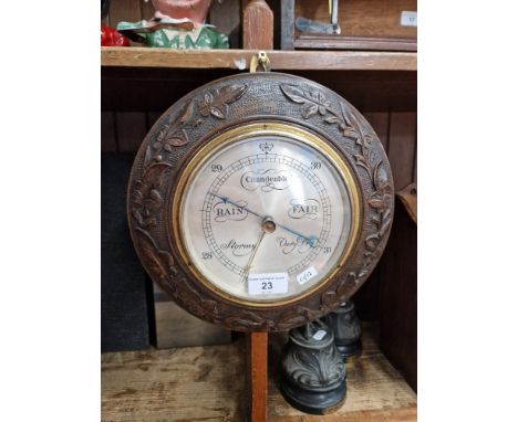 A carved oak barometer 