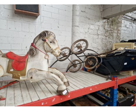 A child's doll pram and a child's rocking horse. 